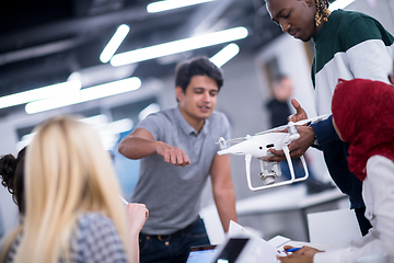 Image showing multiethnic business team learning about drone technology