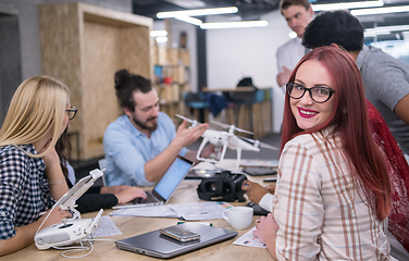 Image showing redhead business woman learning about drone technology