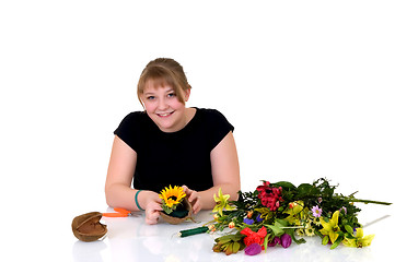 Image showing Young girl arranging flowers 