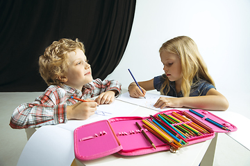 Image showing Boy and girl preparing for school after a long summer break. Back to school.