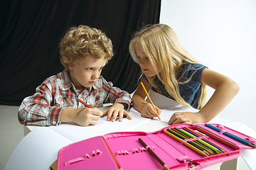 Image showing Boy and girl preparing for school after a long summer break. Back to school.