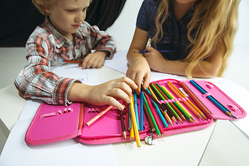 Image showing Boy and girl preparing for school after a long summer break. Back to school.