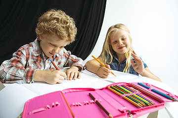 Image showing Boy and girl preparing for school after a long summer break. Back to school.