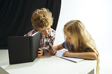 Image showing Boy and girl preparing for school after a long summer break. Back to school.