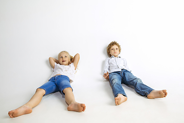 Image showing Boy and girl playing together on white studio background