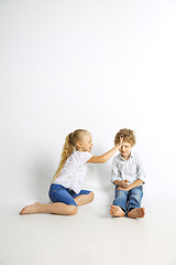 Image showing Boy and girl playing together on white studio background