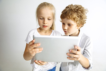 Image showing Boy and girl playing together on white studio background