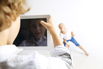 Image showing Boy and girl playing together on white studio background