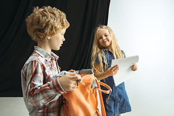 Image showing Boy and girl preparing for school after a long summer break. Back to school.