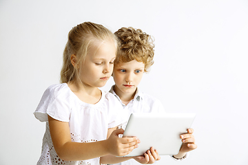 Image showing Boy and girl playing together on white studio background