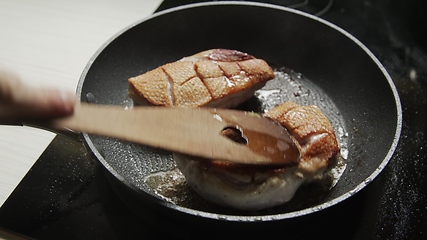 Image showing Roast duck breast in frying pen closeup footage