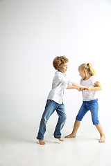 Image showing Boy and girl playing together on white studio background