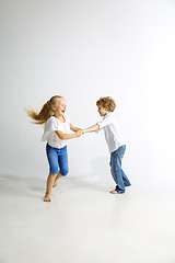 Image showing Boy and girl playing together on white studio background