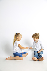 Image showing Boy and girl playing together on white studio background