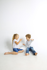 Image showing Boy and girl playing together on white studio background