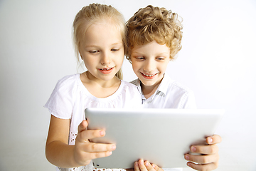 Image showing Boy and girl playing together on white studio background