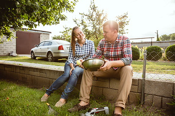 Image showing Young and happy farmer\'s couple at their garden in sunny day