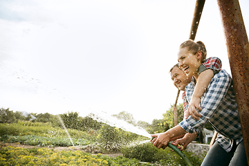 Image showing Young and happy farmer\'s couple at their garden in sunny day