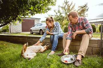 Image showing Young and happy farmer\'s couple at their garden in sunny day