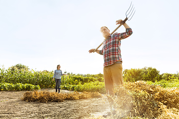 Image showing Young and happy farmer\'s couple at their garden in sunny day