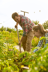 Image showing Young and happy farmer\'s couple at their garden in sunny day