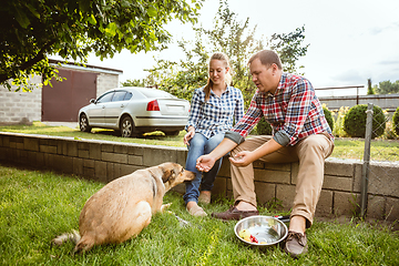 Image showing Young and happy farmer\'s couple at their garden in sunny day