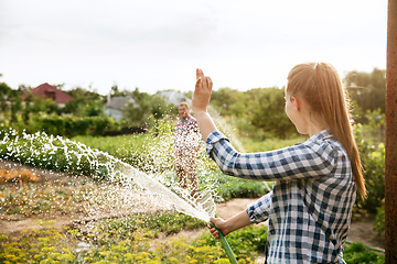 Image showing Young and happy farmer\'s couple at their garden in sunny day