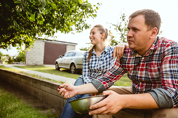 Image showing Young and happy farmer\'s couple at their garden in sunny day