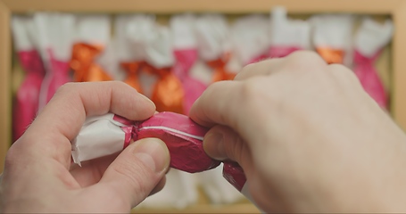 Image showing Man opening christmas choclate closeup footage