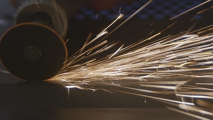 Image showing Steel cutter with sparks while cutting steel bar