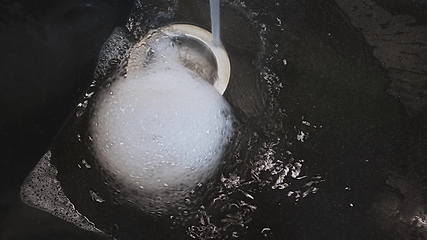 Image showing Foam and water whirling in wash basin