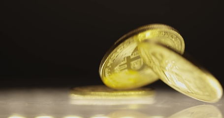 Image showing Shiny bitcoin falling down on steel surface slow motion 120 fps