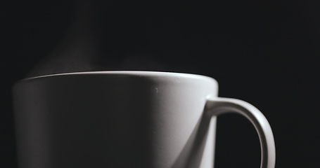 Image showing Vapor rising from hot mug closeup footage