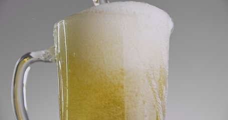 Image showing Beer overflowing from large mug 120fps slow motion footage