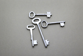 Image showing Many old vintage keys on a beige background