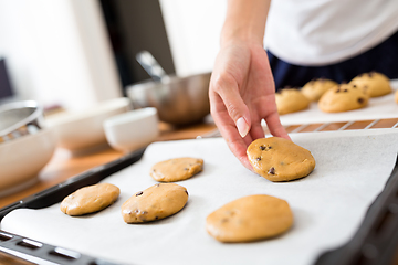 Image showing Woman putting paste on metal tray and prepare to cook