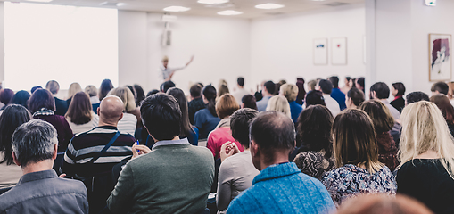 Image showing Woman giving interactive motivational speech at entrepreneurship workshop.