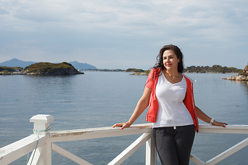 Image showing Young woman against view on norwegian fjords