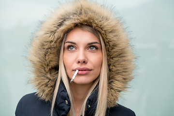 Image showing portrait of young blonde girl with cigarette in the mouth