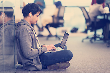 Image showing software developer working on the floor