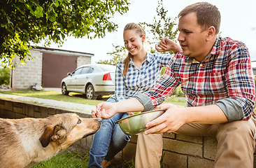 Image showing Young and happy farmer\'s couple at their garden in sunny day