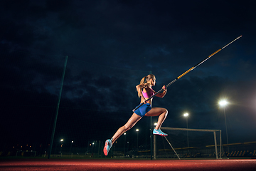 Image showing Female pole vaulter training at the stadium in the evening