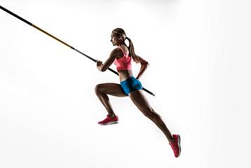 Image showing Female pole vaulter training on white studio background