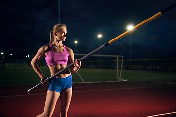 Image showing Female pole vaulter training at the stadium in the evening