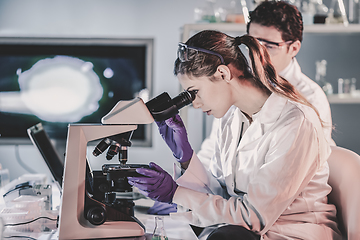 Image showing Young researchers researching in life science laboratory.