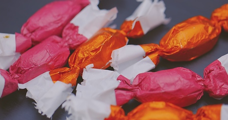 Image showing Christmas candy lying on the table with camera in motion closeup