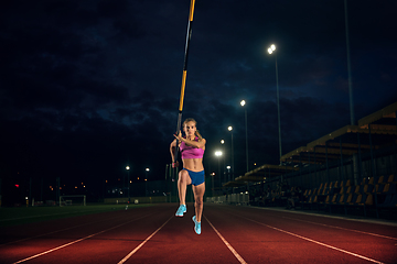 Image showing Female pole vaulter training at the stadium in the evening