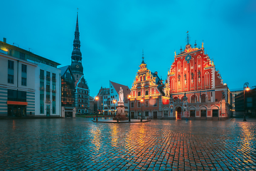 Image showing Riga, Latvia. Scenic Town Hall Square With St. Peter\'s Church, Schwabe House, House Of Blackheads During Night Rain. Popular Showplace With Famous Landmarks On It In Bright Evening Illumination In Su