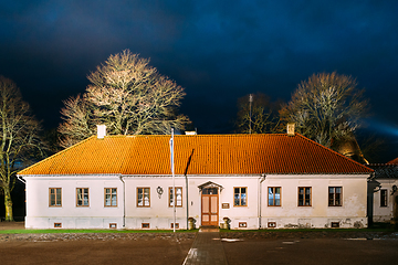 Image showing Kuressaare, Saaremaa Island, Estonia. Museum Old House Building Near Episcopal Castle In Evening Blue Hour Night. Traditional Medieval Architecture, Famous Attraction Landmark