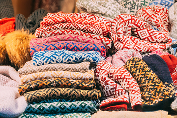 Image showing Various Colorful Knitted Traditional European Warm Clothes - Scarfs At Winter Christmas Market. Winter Souvenir